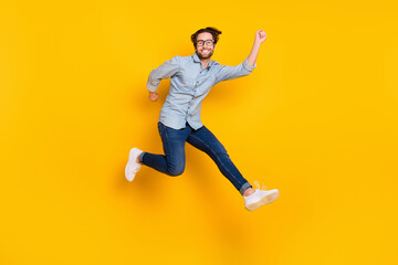 Fototapeta na wymiar Full size profile side photo of young man happy positive smile have fun jump go walk isolated over yellow color background