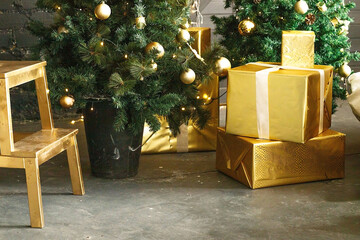 Christmas tree with wooden rustic decorations and presents under it in loft interior.