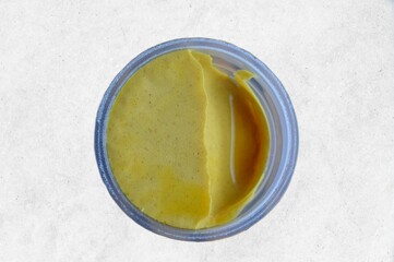 jar of mustard on a white background