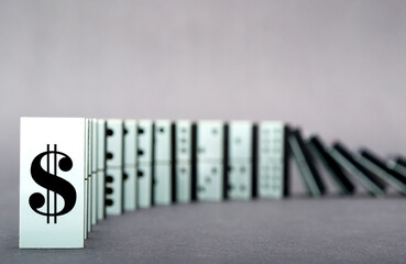 Dominoes falling in a row , gray background