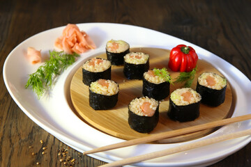 Sushi Set - Different Types of Maki Sushi and Nigiri Sushi. Served on dark wooden table.
