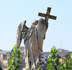 Back View of the Angel with the Cross Statue on the Ponte Sant'Angelo in Rome, Italy
