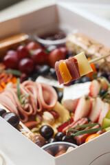 Charcuterie board platter of different cheeses, ham and jam. perfect for Sunday brunch
