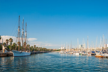 Fototapeta na wymiar Royal Yacht Club of Barcelona. Yachts against the backdrop of blue clear skies and azure waters of the sea.