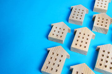 Many houses on a blue background. Searching for options in real estate market. Realtor services. Selection criteria options. Search for housing. Copy space. Best deal for buying a home.