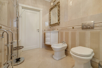 toilet and detail of a corner shower cabin with wall mount shower attachment