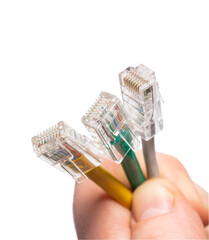 colored wires with rj45 connectors in the hands of a man in close-up