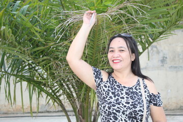 woman on Hand touch in a palm leaf beautiful smile