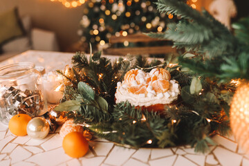 Christmas holiday cake decorated with tangerines and Christmas tree branches, Traditional festive sweet food. Selective focus
