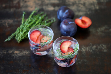 Healthy detox drink plum thyme. Mineral water with thyme and plum.