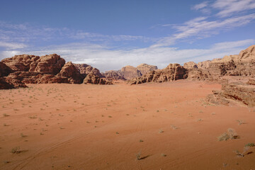 Fototapeta premium deserted valley in the Wadi Rum desert, car tire tracks in the sand, nature of Jordan