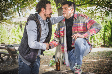 Cheers. Smiling cheerful young friends drinks beer from bottle