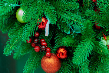 Beautiful winter background. New Year background with spruce and decorations. Winter Christmas scene. Red balls on fir branches, winter snowy backdrop. template for design.