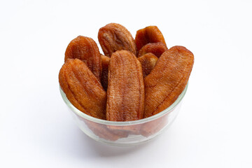 Sun dried bananas in glass bowl on white background.