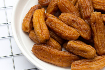 Sun-dried bananas on white background.