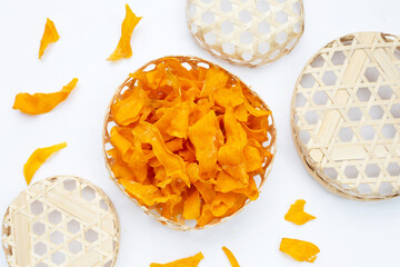 Sweet potato chips in bamboo basket on white background.
