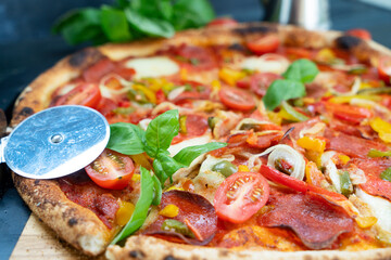 Pizza with salami and tomatoes