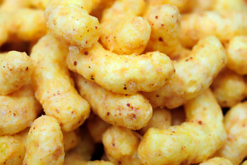 Puffed corn snacks with peanuts and cheese flavor