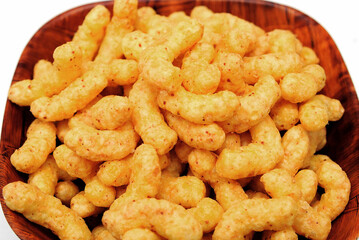 Puffed corn snacks with peanuts and cheese flavor