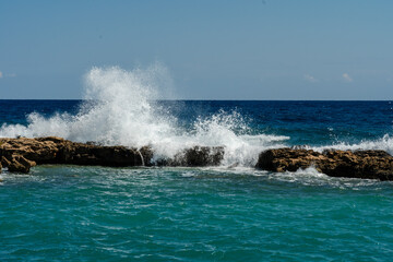 Sea waves break at rock during storm