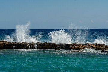 Sea waves splashing on rock during storm