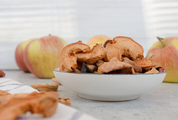 Red dried apples on the gray table close up