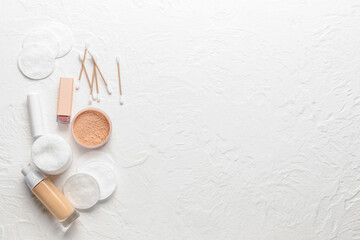 Cotton pads, cotton buds and cosmetics on white background