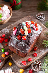 Homemade Christmas cake with wild berries on wooden background