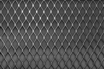 Metal grid with geometric pattern of rhombi, background. Black metallic modern background