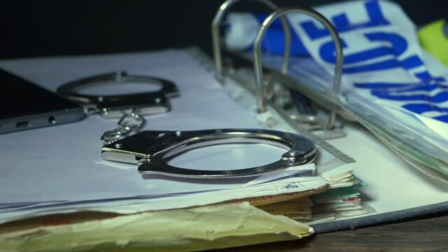 Handcuffs and documents in a police criminal investigation
