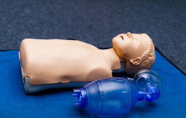First medical help training equipment. Medical dummy and oxygen mask. Close up