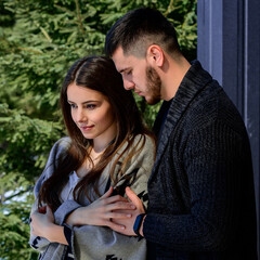 Fototapeta premium Portrait of a young couple in the backyard near the house