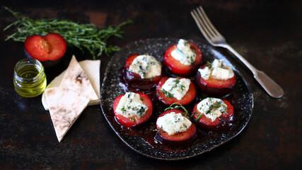 Fototapeta na wymiar Baked plums with blue cheese and thyme. Autumn snack.