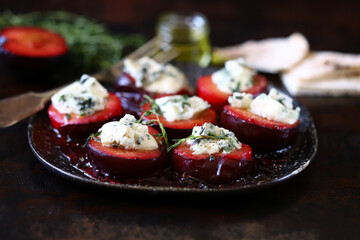 Baked plums with blue cheese and thyme. Autumn snack.