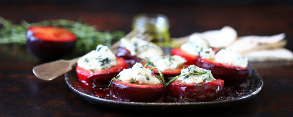 Baked plums with blue cheese and thyme. Autumn snack.