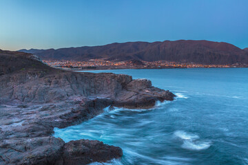 Pacific coast in the north of Chile with the city of Taltal in the background in the blue hour before sunrise