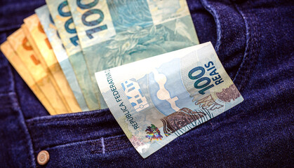 Brazilian money bills, one hundred and fifty reais bills in pants pockets, prize or jackpot concept