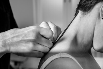 Osteopathic doctor glues elastic tapes to the neck for treatment. Medicine
