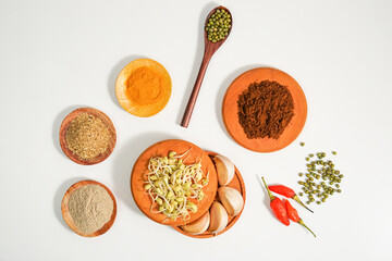 a culinary background decorated with the assortment of condiment recipes. spices and herbs on a white background shot from the top view. suitable for header background, website, and social media post.