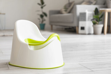 Potty on grey floor in room