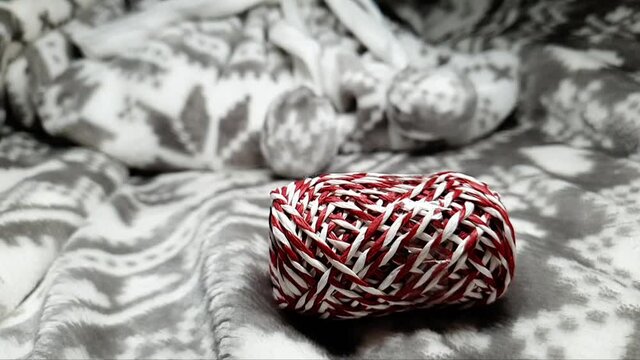 Ribbons for wrapping gifts for Christmas and New Year. Gift wrapping for Christmas. Red, white and silver ribbons in spools fall onto the soft blanket. Festive background.