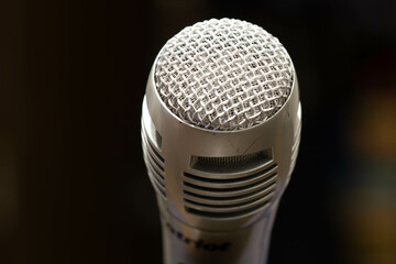 Professional microphone in a music studio on a black background. Record sounds and songs. Chrome...