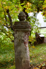 fretwork on column in red bricks Garden with tall poplar trees terracotta brick pillar