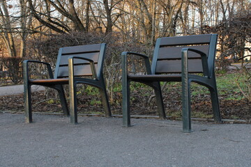 Fototapeta na wymiar two chairs in a city park 