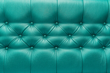 Fototapeta na wymiar Green or aquamarine leather upholstery sofa with pattern button design furniture style decor texture background