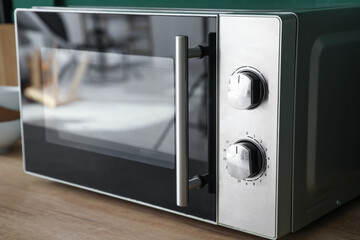 Fototapeta premium Modern microwave oven in kitchen, closeup