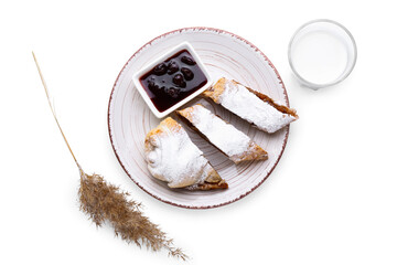 Plate with tasty pumpkin strudel, jam and glass of milk on white background