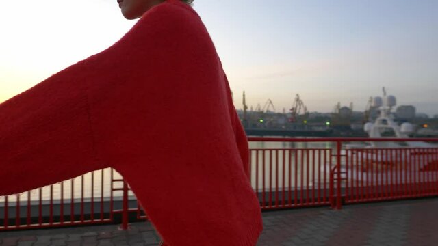 Cute teenage girl rollerskating at sunrise, urban sports, fun leisure activity in sea port, teenage lifestyle