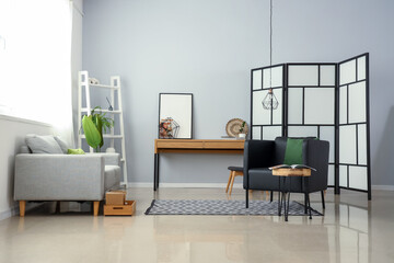 Interior of stylish living room with modern armchair and table