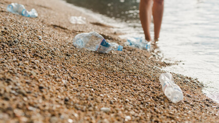 The sea beach is polluted with plastic bottles. Volunteering. Environmental pollution. Ecological problem. Selective focus.